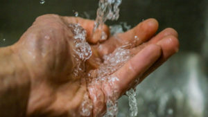 Clean water running into person's hand