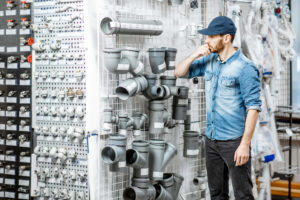 Man choosing pipes in a home store