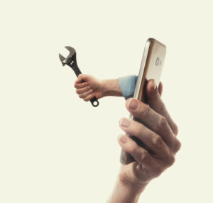 iPhone with hand holding a tool coming out of it